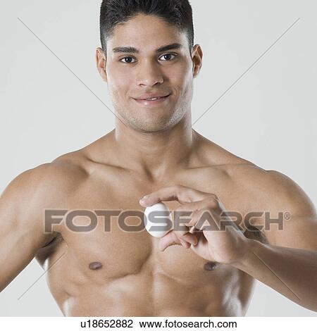 Portrait of a young man holding an egg View Large Photo Image Stock Image - Portrait of a young man holding an egg. Fotosearch