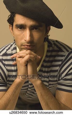 Portrait of a young man sitting with his hands clasped View Large Photo Image Stock Image - Portrait of a young man sitting with his hands clasped. Fotosearch