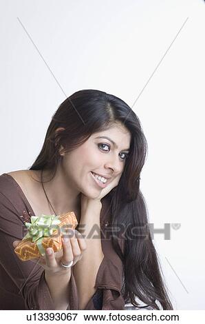 Portrait of a young woman holding a present View Large Photo Image Stock Photo - Portrait of a young woman holding a present. Fotosearch