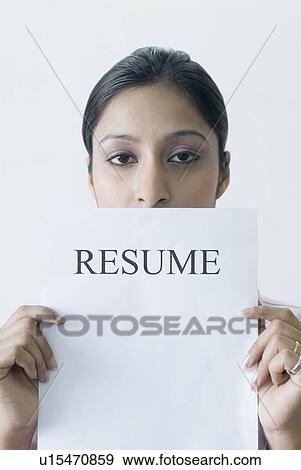 Portrait of a young woman holding a resume View Large Photo Image Stock Photo - Portrait of a young woman holding a resume. Fotosearch