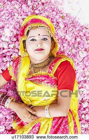 Portrait of a young woman in a stage costume and lying on a bed of rose petals View Large Photo Image Stock Image - Portrait of a young woman in a stage costume and lying on a bed of rose petals. Fotosearch