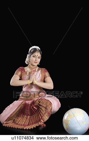 Picture - Portrait of a young woman performing Bharatnatyam. Fotosearch
