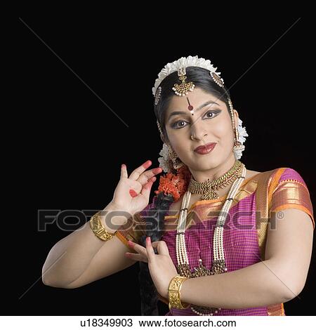 Stock Image - Portrait of a young woman performing Bharatnatyam. Fotosearch
