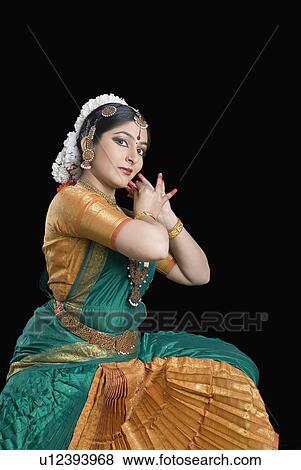 Portrait of a young woman performing Bharatnatyam View Large Photo Image Stock Photo - Portrait of a young woman performing Bharatnatyam. Fotosearch
