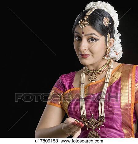 Portrait of a young woman performing Bharatnatyam View Large Photo Image Stock Photo - Portrait of a young woman performing Bharatnatyam. Fotosearch