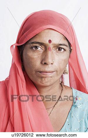 Stock Image - Portrait of a young woman smirking. Fotosearch