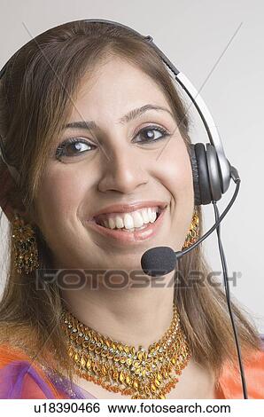Portrait of a young woman wearing a headset View Large Photo Image Stock Photograph - Portrait of a young woman wearing a headset. Fotosearch