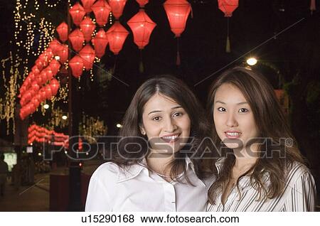 Stock Photo - Portrait of two young women smiling. Fotosearch