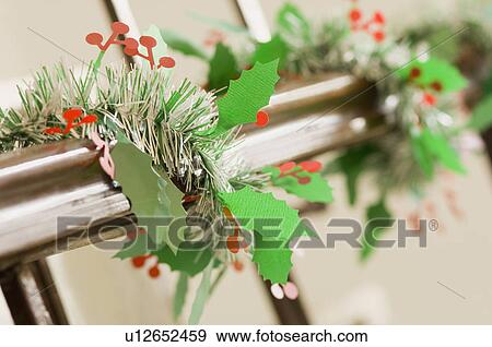 Stock Photo - Railing decorated with Christmas holly. Fotosearch