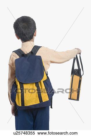 Stock Photography - Rear view of a school boy holding a water bottle. Fotosearch