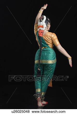 Rear view of a young woman performing Bharatnatyam View Large Photo Image Stock Photo - Rear view of a young woman performing Bharatnatyam. Fotosearch