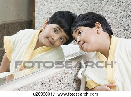 Reflection of a girl in a bathroom mirror View Large Photo Image Stock Photo - Reflection of a girl in a bathroom mirror. Fotosearch
