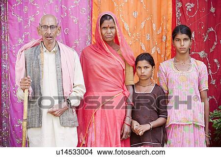 Senior man and a mature woman standing with their two granddaughters View Large Photo Image Picture - Senior man and a mature woman standing with their two granddaughters. Fotosearch
