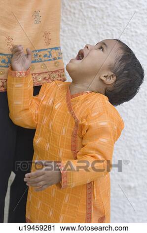 Stock Image - Side profile of a boy crying. Fotosearch