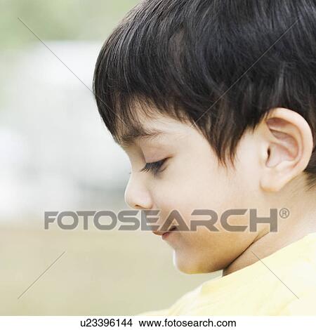 Picture - Side profile of a boy looking down. Fotosearch