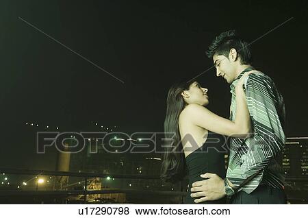 Stock Photo - Side profile of a young couple dancing. Fotosearch