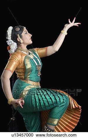 Stock Image - Side profile of a young woman performing Bharatnatyam. Fotosearch