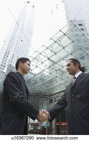 Side profile of two businessmen shaking hands View Large Photo Image Stock Image - Side profile of two businessmen shaking hands. Fotosearch