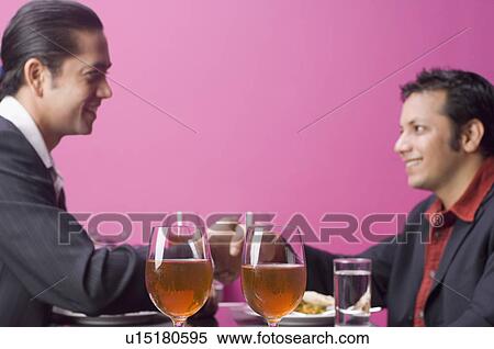 Side profile of two businessmen shaking hands View Large Photo Image Stock Photography - Side profile of two businessmen shaking hands. Fotosearch