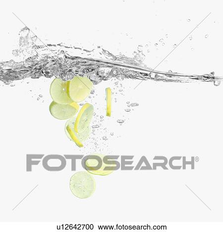 Stock Image - Slices of a lemon underwater. Fotosearch