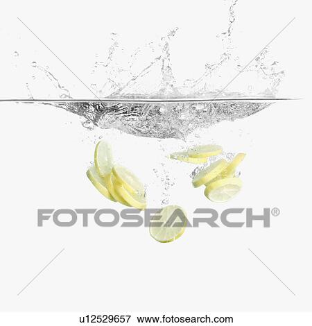 Stock Photo - Slices of a lemon underwater. Fotosearch