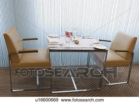 Table and chairs in a restaurant View Large Photo Image Stock Photo - Table and chairs in a restaurant. Fotosearch