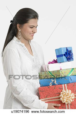 Teenage girl carrying gifts and smiling View Large Photo Image Stock Photograph - Teenage girl carrying gifts and smiling. Fotosearch