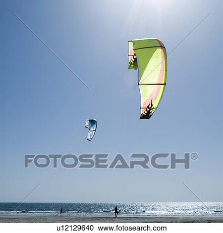 Stock Image - Two parachutes over the sea, Morjim Beach, Goa, India. Fotosearch