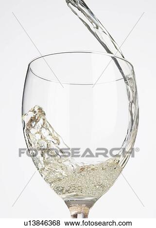 Wine being poured into a wine glass View Large Photo Image Stock Photo - Wine being poured into a wine glass. Fotosearch