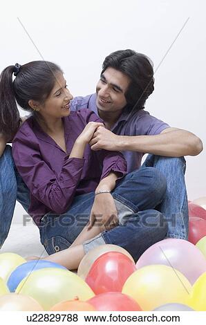 Young couple looking at each other and smiling View Large Photo Image Stock Photo - Young couple looking at each other and smiling. Fotosearch