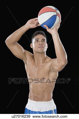 Stock Photo - Young man playing a basketball. Fotosearch