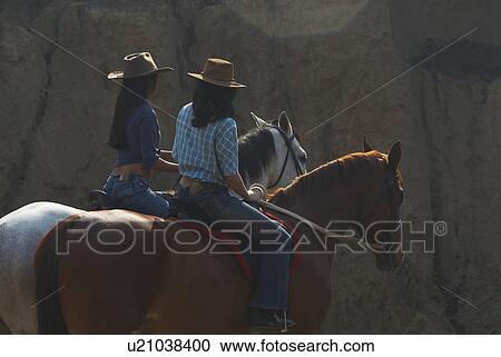 Young woman and a teenage girl riding horses View Large Photo Image Stock Image - Young woman and a teenage girl riding horses. Fotosearch