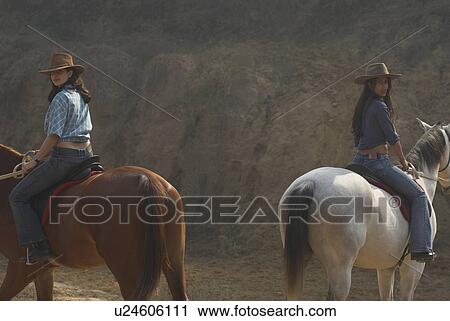 Young woman and a teenage girl riding horses View Large Photo Image Stock Image - Young woman and a teenage girl riding horses. Fotosearch