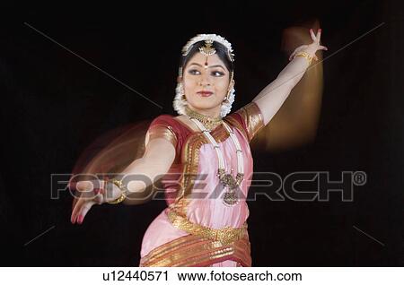 Stock Image - Young woman performing Bharatnatyam. Fotosearch