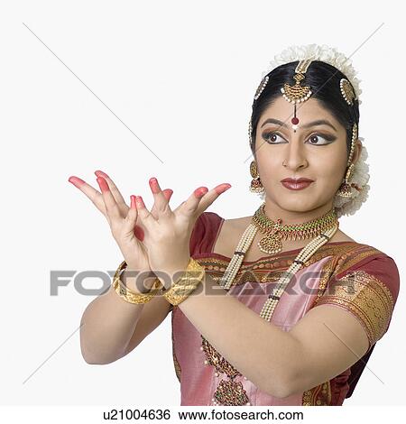 Stock Photograph - Young woman performing Bharatnatyam. Fotosearch