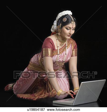 Stock Photo - Young woman using a laptop. Fotosearch