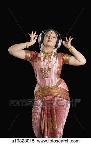Young woman wearing headphones and performing Bharatnatyam View Large Photo Image Stock Photography - Young woman wearing headphones and performing Bharatnatyam. Fotosearch