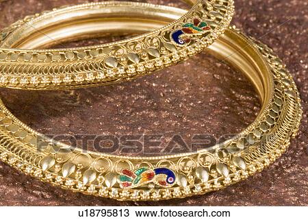 Stock Image - Close-up of golden bracelets. Fotosearch