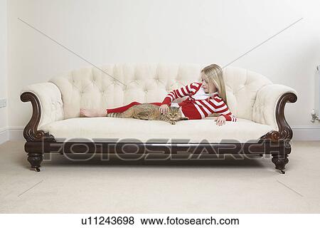 Girl and cat on sofa View Large Photo Image Stock Photo - Girl and cat on sofa. Fotosearch