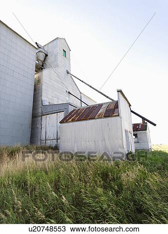 Stock Image - Abandoned agricultural building in rural area. Fotosearch