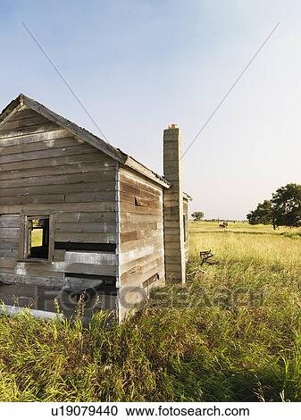 Stock Image - Abandoned rural wooden house in state of disrepair. Fotosearch