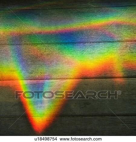 Picture - Abstract design of rainbow color prism on wood paneling.. Fotosearch
