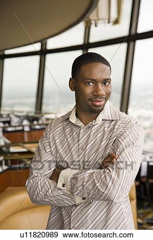 Adult man smiling at viewer with arms crossed View Large Photo Image Stock Photo - Adult man smiling at viewer with arms crossed. Fotosearch