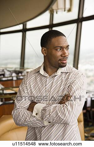 Stock Photo - Adult man with arms crossed. Fotosearch