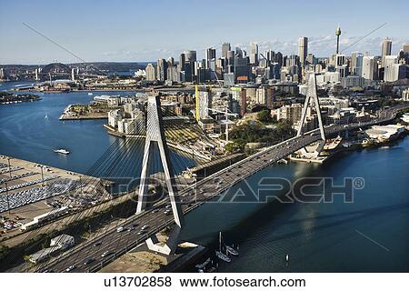 Stock Photo - Aerial view of Anzac Bridge and buildings in Sydney, Australia.. Fotosearch