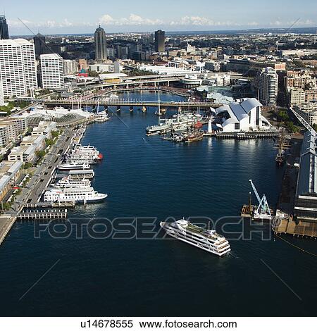 Stock Photography - Aerial view of ships and boats in Darling Harbour with view of skyscrapers in Sydney, Australia.. Fotosearch