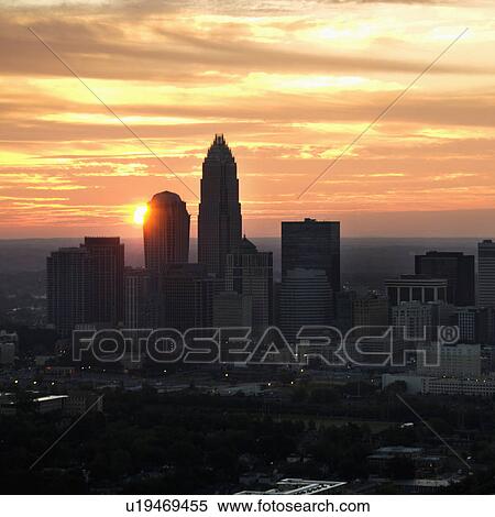 Stock Photography - Aerial view of sunset behind city skyline of Charlotte, North Carolina. Fotosearch