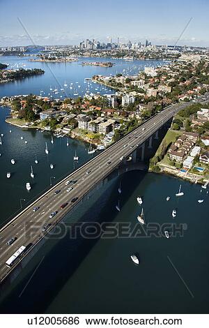 Aerial view of Victoria Road bridge and boats with distant downtown skyline in Sydney, Australia. View Large Photo Image Stock Photograph - Aerial view of Victoria Road bridge and boats with distant downtown skyline in Sydney, Australia.. Fotosearch