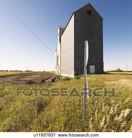 Stock Photo - Agricultural grain elevator in rural field. Fotosearch