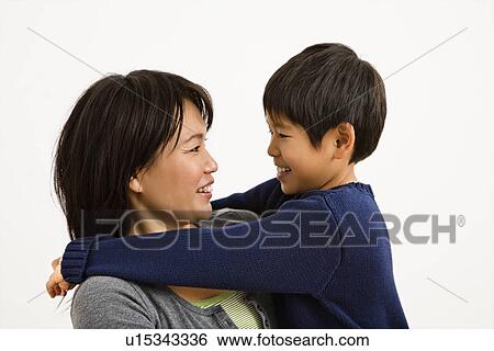 Asian mother and son hugging and smiling. View Large Photo Image Stock Photograph - Asian mother and son hugging and smiling.. Fotosearch